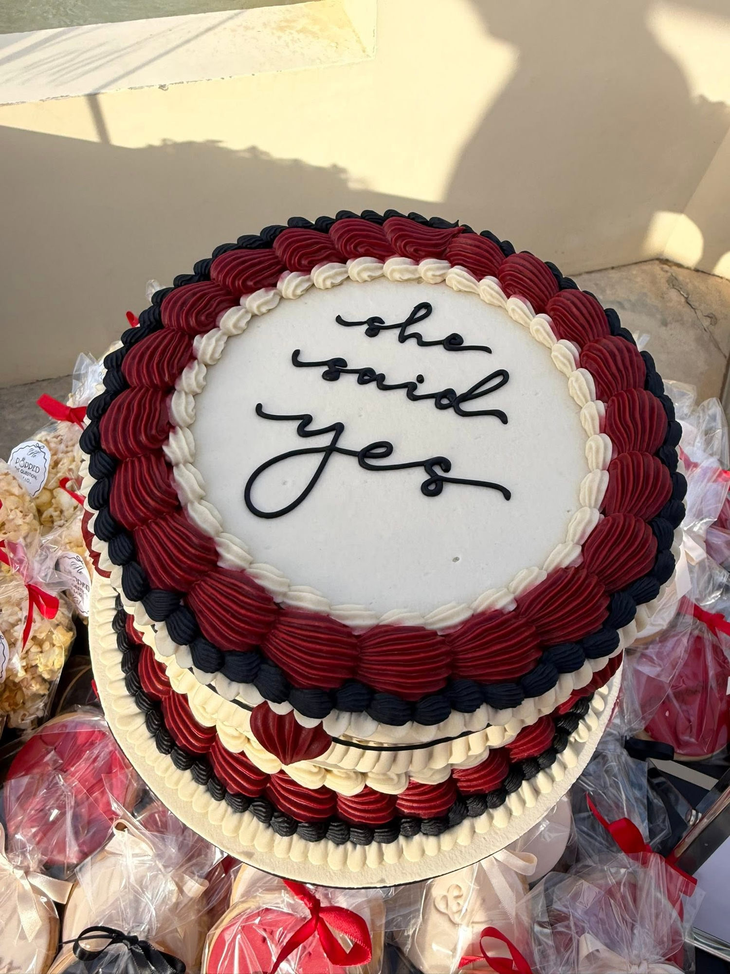 Celebration cake reading 'she said yes'
